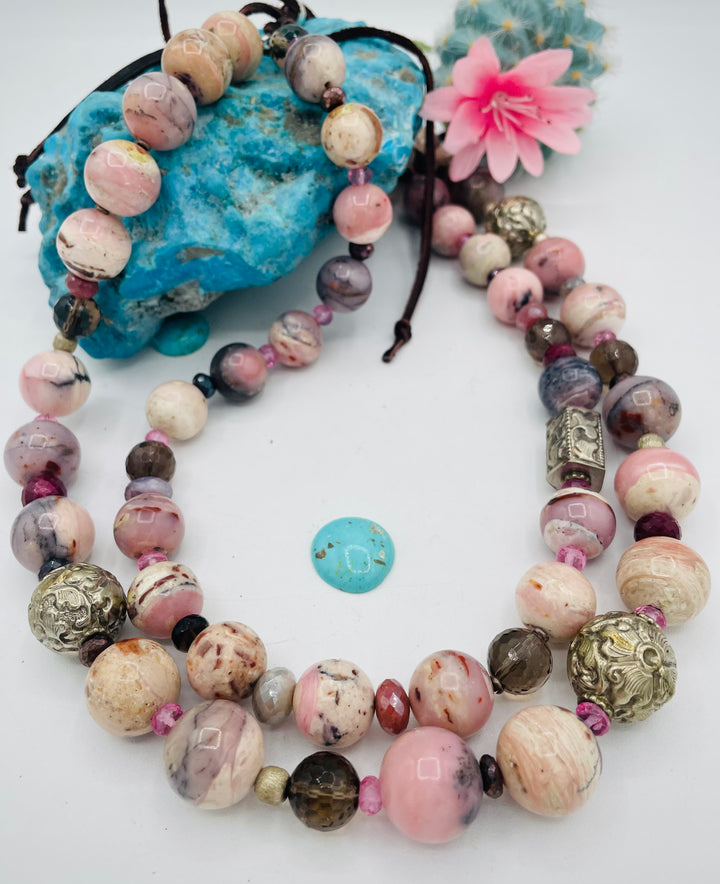 Beaded necklace featuring pink opal, repousse beads, smokey quartz, ruby, pink topaz, sterling silver beads, moonstone, and finished with deer lace in the back. Available only from Rockstar Cowgirl online or in store in Cody, Wyoming.