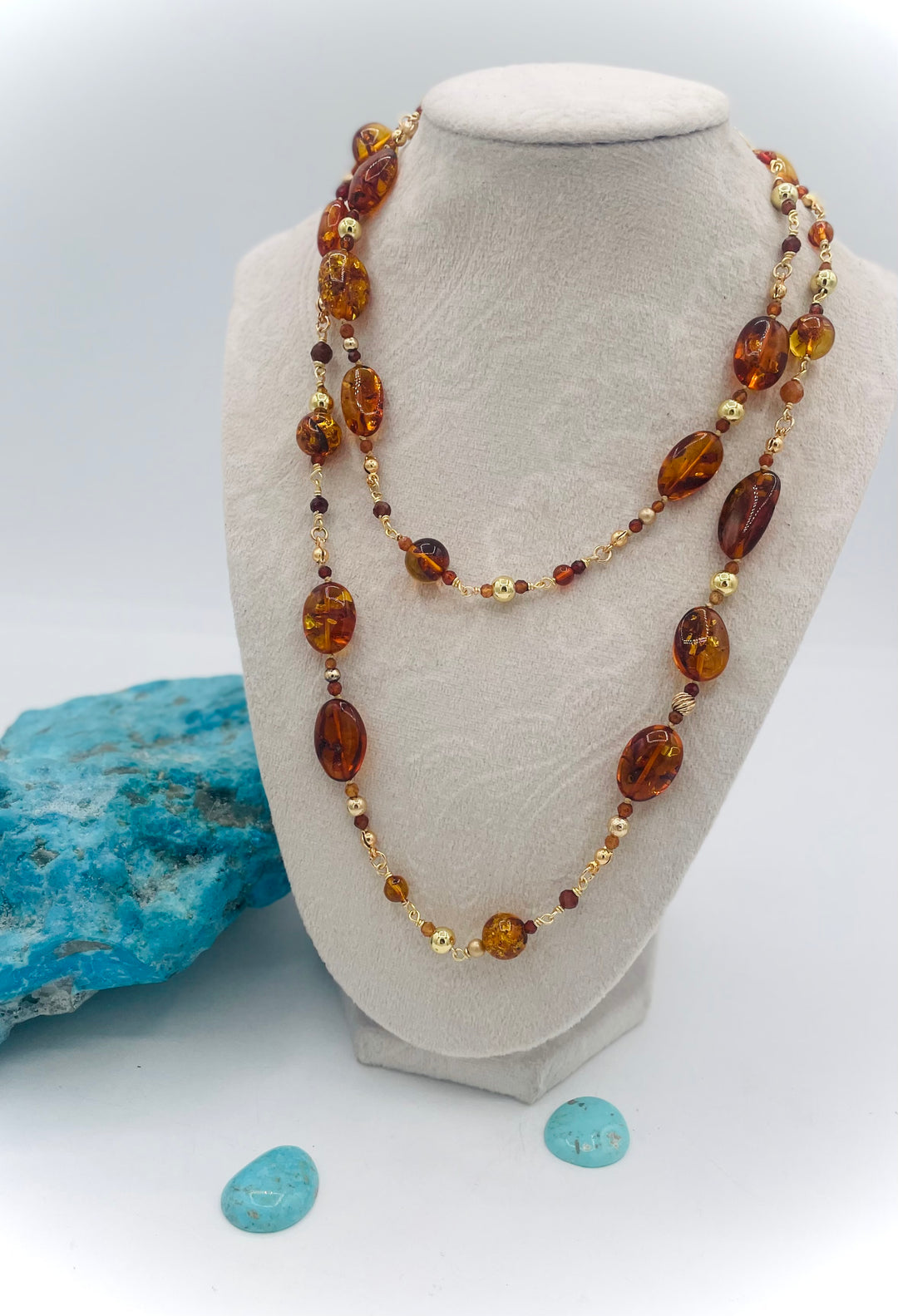 Silk knotted and wire wrapped treasure necklace featuring Baltic amber, Hessonite garnet, and gold accents. Available only from Rockstar Cowgirl online or in store in Cody, Wyoming.