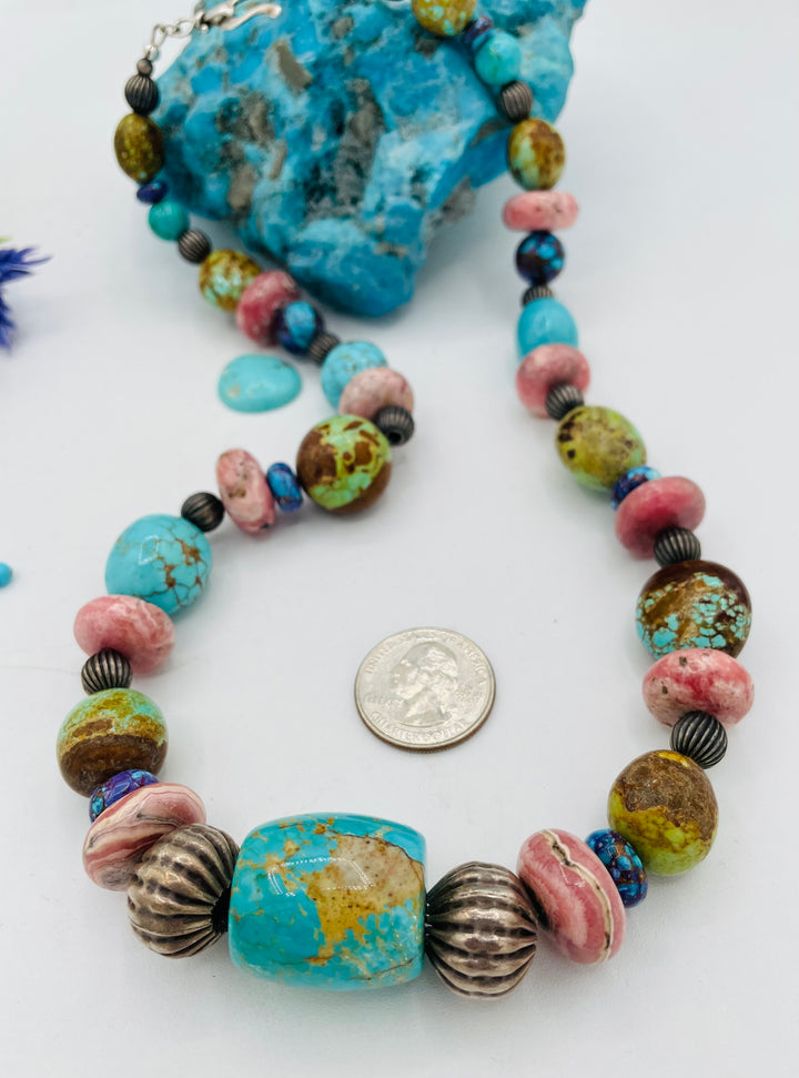 Beaded necklace featuring #8 turquoise, Kingman turquoise, purple Mojave turquoise, Rhodochrosite, and sterling silver beads. U.S. quarter for size reference. Available only from Rockstar Cowgirl online or  store in Cody, Wyoming.