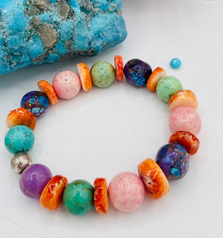Stretch bracelet featuring Mojave turquoise, rhodochrosite, spiney oyster, variscite, sterling silver, phosphosiderite, and turquoise beads. Available only from Rockstar Cowgirl online or in store in Cody, Wyoming.