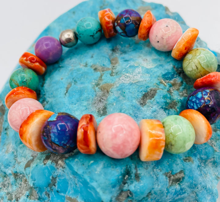 Stretch bracelet featuring Mojave turquoise, rhodochrosite, spiney oyster, variscite, sterling silver, phosphosiderite, and turquoise beads. Available only from Rockstar Cowgirl online or in store in Cody, Wyoming.