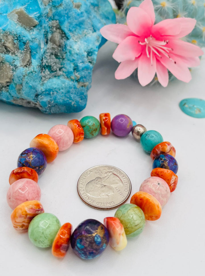 Stretch bracelet featuring Mojave turquoise, rhodochrosite, spiney oyster, variscite, sterling silver, phosphosiderite, and turquoise beads. U.S. quarter for size reference. Available only from Rockstar Cowgirl online or in store in Cody, Wyoming.