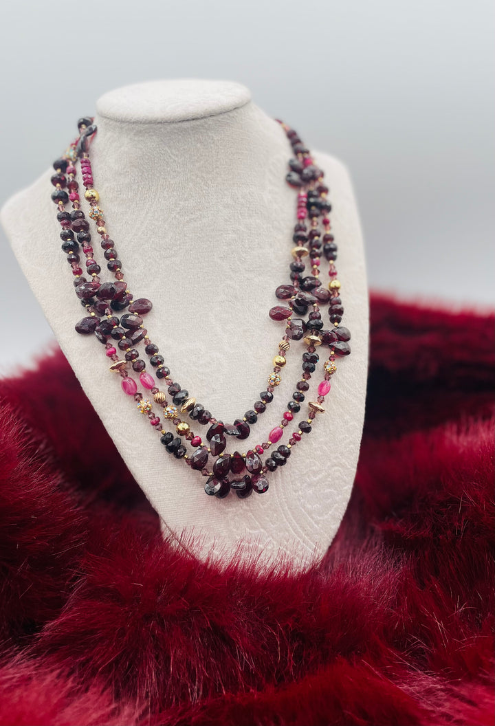 Nested 3 strand necklace featuring garnets, rubies, purple crystals, 14K gold accents, and African brass spacers. Available only from Rockstar Cowgirl online or in store in Cody, Wyoming.