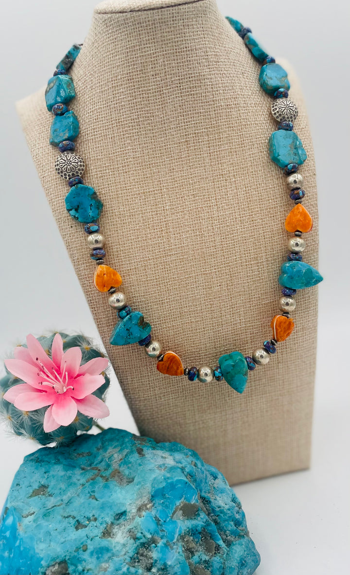 Adjustable beaded hatband featuring Kingman turquoise, purple Mojave turquoise, spiney oyster and turquoise hearts, sterling silver beads, and finished with deer lace in the back. Available only from Rockstar Cowgirl online or in store in Cody, Wyoming.