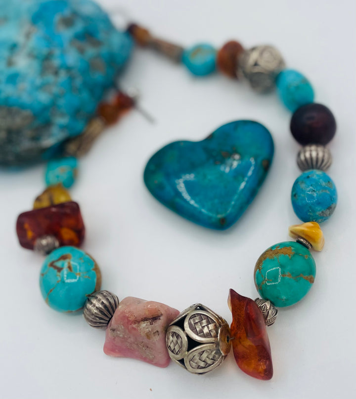 Chunky beaded necklace featuring Kingman turquoise, Ithaca Peak turquoise, textured deer antler, Baltic amber, pink opal, and sterling silver beads. Available only from Rockstar Cowgirl online or in store in Cody, Wyoming.