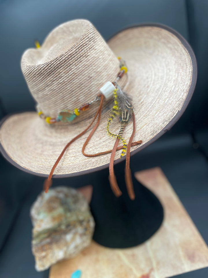Close up of the back of the hatband highlighting the antler sliding bead, the feathers, and the soft deer laces.