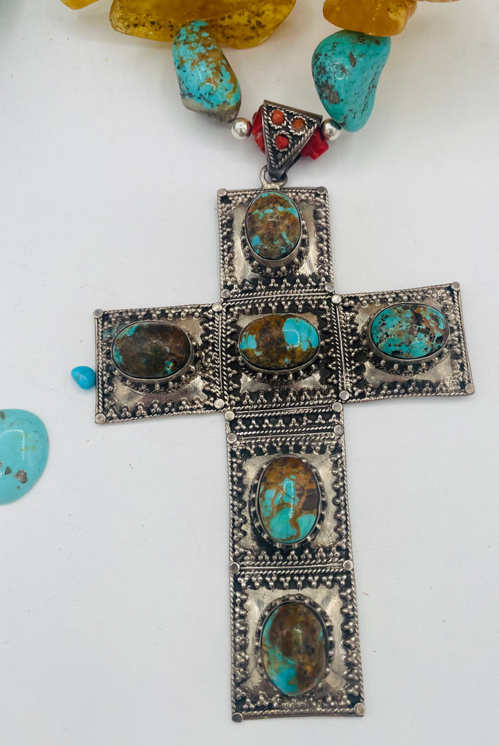 Beaded necklace featuring #8 turquoise, yellow Baltic amber, coral, sterling silver beads, silver and coral tube beads, and a sterling silver cross with #8 turquoise nuggets. Available only from Rockstar Cowgirl online or in store in Cody, Wyoming.