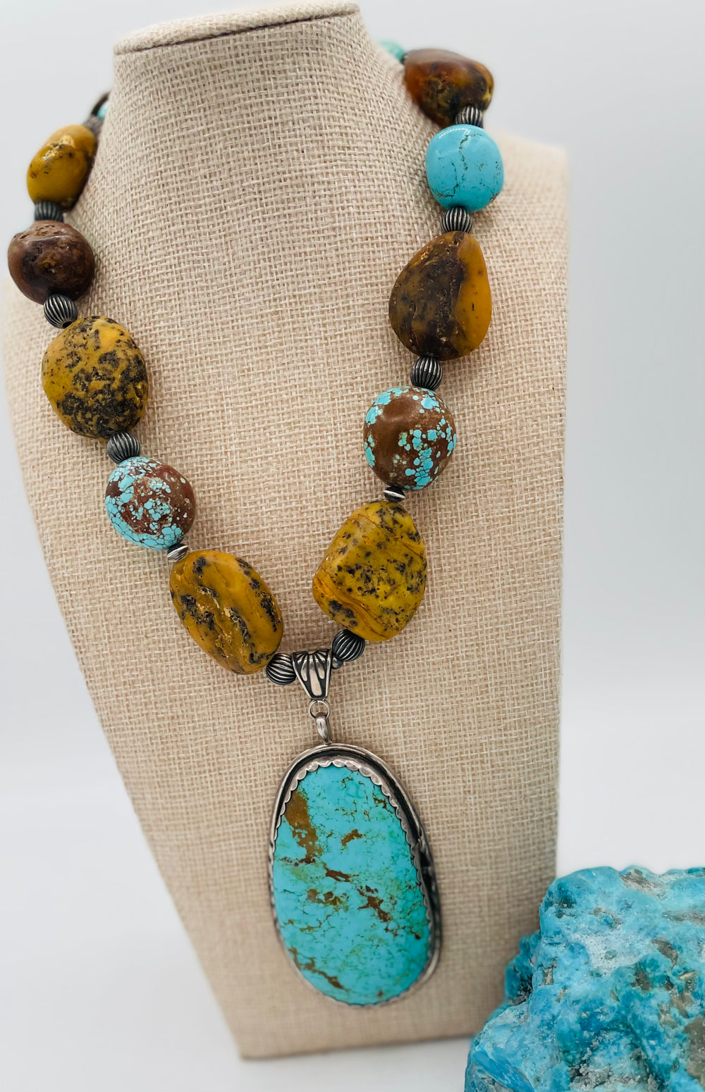 Necklace featuring Kingman turquoise, #8 turquoise, yellow and black Baltic Amber, and sterling silver beads with a Kingman turquoise and sterling silver pendent. Available only from Rockstar Cowgirl online or in store in Cody, Wyoming.