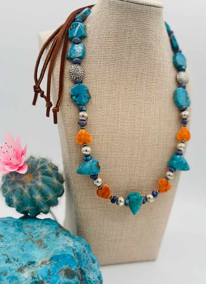 Adjustable beaded hatband featuring Kingman turquoise, purple Mojave turquoise, spiney oyster and turquoise hearts, sterling silver beads, and finished with deer lace in the back. Available only from Rockstar Cowgirl online or in store in Cody, Wyoming.