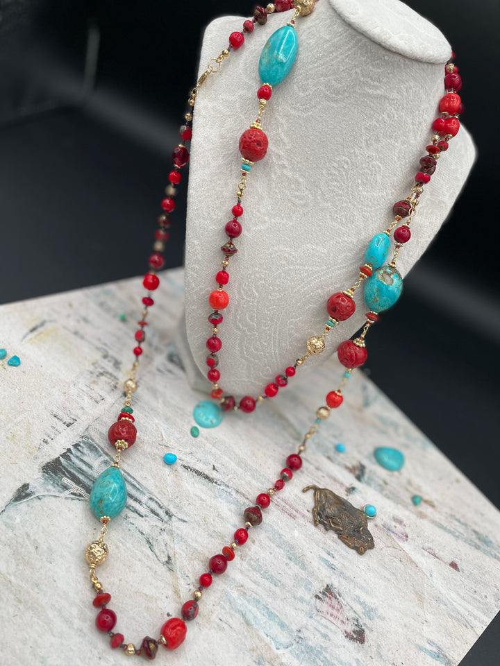 Silk knotted and wire wrapped extra long treasure necklace featuring Kingman Turquoise, red coral, red travertine beads, vintage Japanese cherry beads, and gold lava beads. Available only from Rockstar Cowgirl online or in store in Cody, Wyoming.