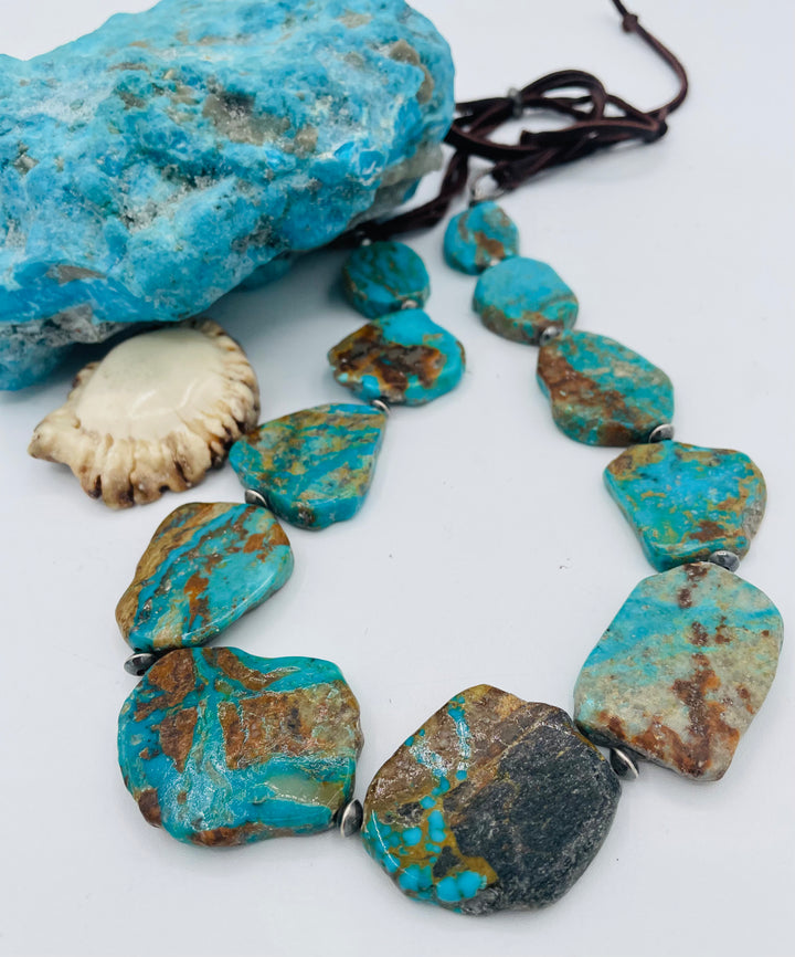 Adjustable beaded hatband that double as a necklace featuring Kingman turquoise flats and sterling silver beads finished with deer lace in the back. Available only from Rockstar Cowgirl online or in store in Cody, Wyoming.