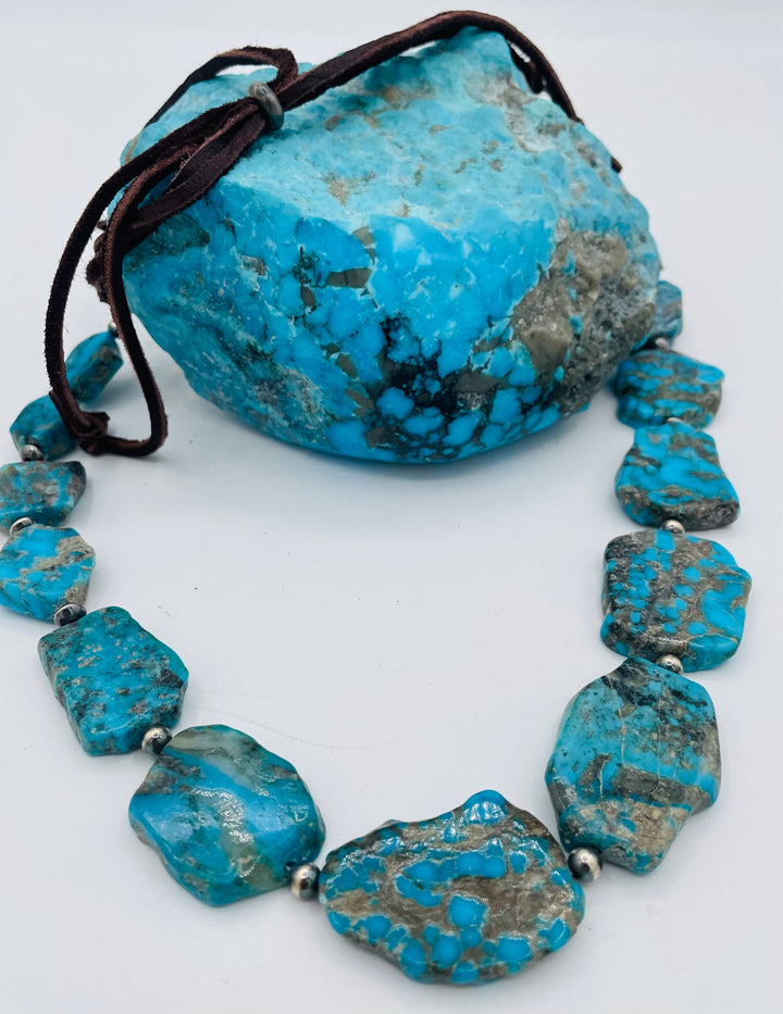 Adjustable beaded hatband that doubles as a necklace featuring Ithaca Peak turquoise and sterling silver beads and finished with deer lace in the back. Available only from Rockstar Cowgirl online or in store in Cody,, Wyoming.