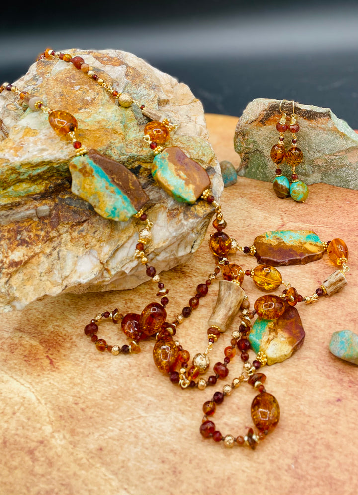 A close up highlighting the Matrix in the Kingman Turquoise and the honey coloring of the Baltic amber and garnets in this silk knotted treasure necklace with matching earrings. Available only from Rockstar Cowgirl online and in store in 
Cody, Wyoming.