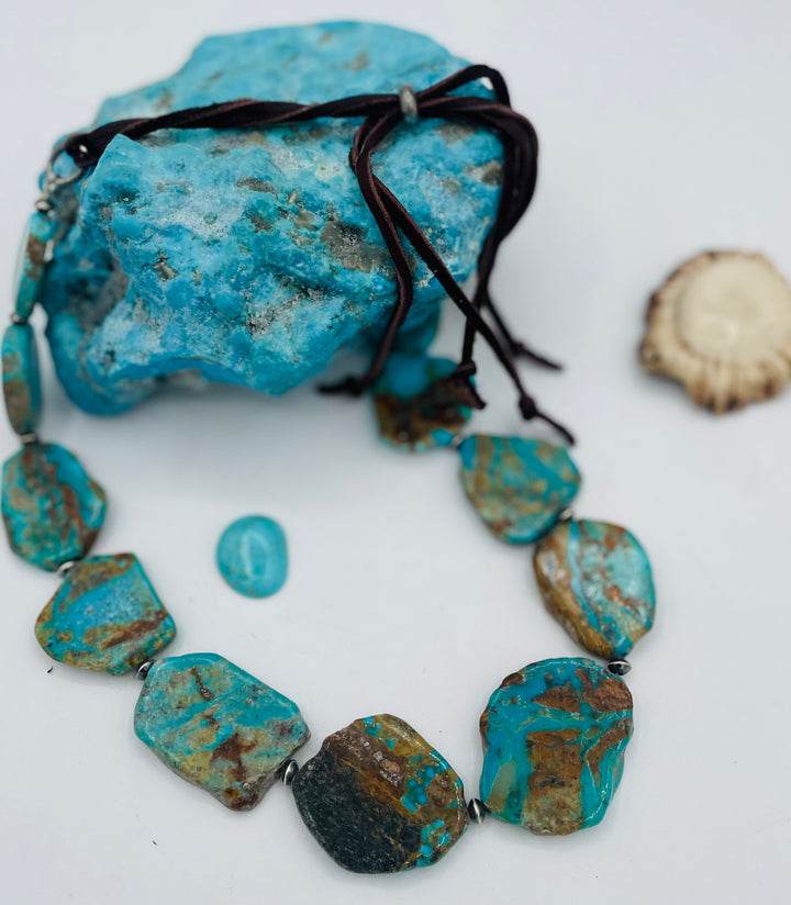 Adjustable beaded hatband that double as a necklace featuring Kingman turquoise flats and sterling silver beads finished with deer lace in the back. Available only from Rockstar Cowgirl online or in store in Cody, Wyoming.