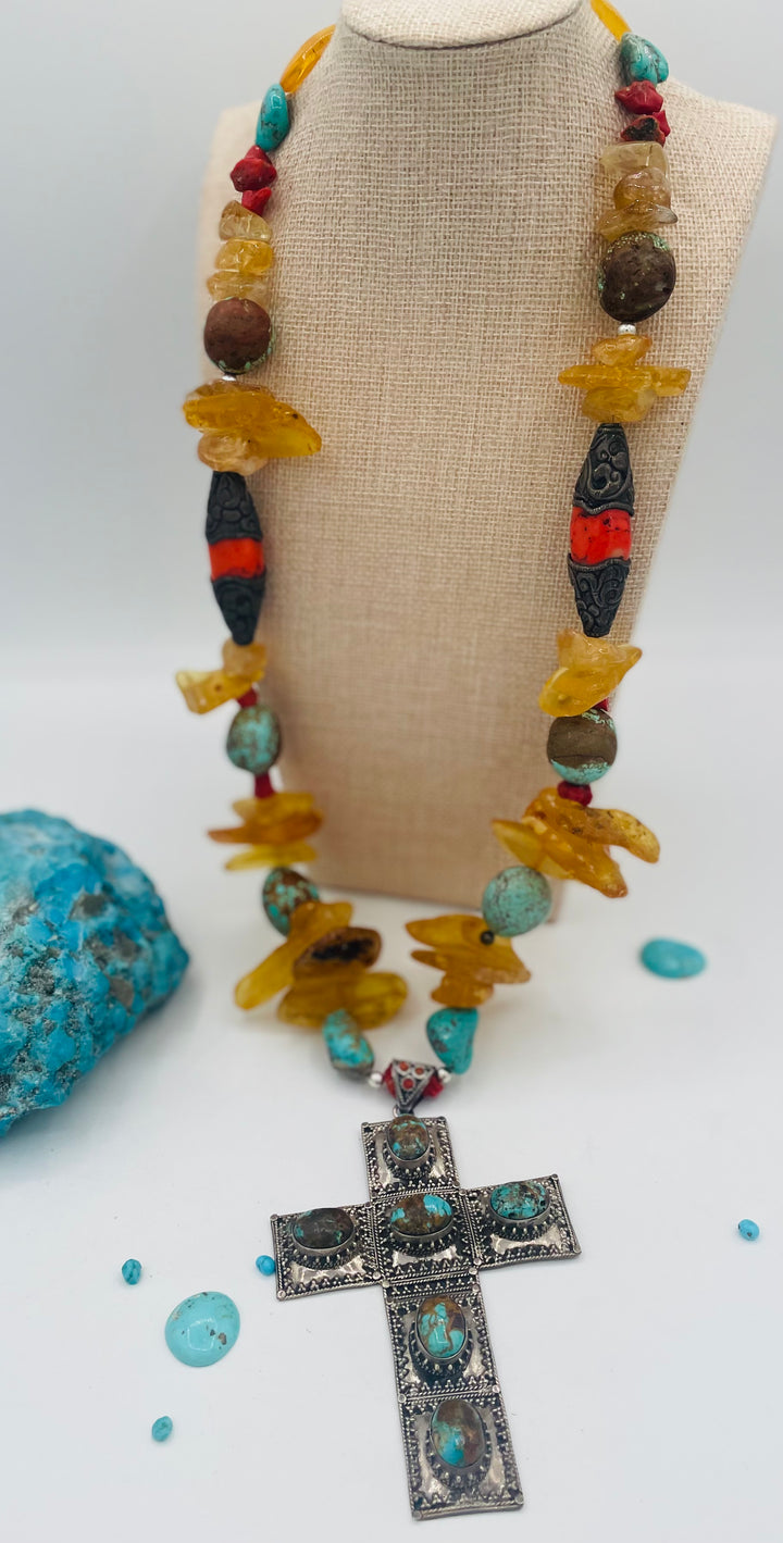 Beaded necklace featuring #8 turquoise, yellow Baltic amber, coral, sterling silver beads, silver and coral tube beads, and a sterling silver cross with #8 turquoise nuggets. Available only from Rockstar Cowgirl online or in store in Cody, Wyoming.