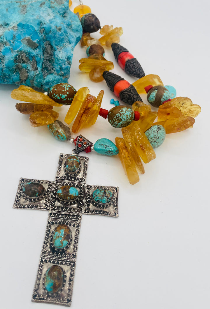 Beaded necklace featuring #8 turquoise, yellow Baltic amber, coral, sterling silver beads, silver and coral tube beads, and a sterling silver cross with #8 turquoise nuggets. Available only from Rockstar Cowgirl online or in store in Cody, Wyoming.