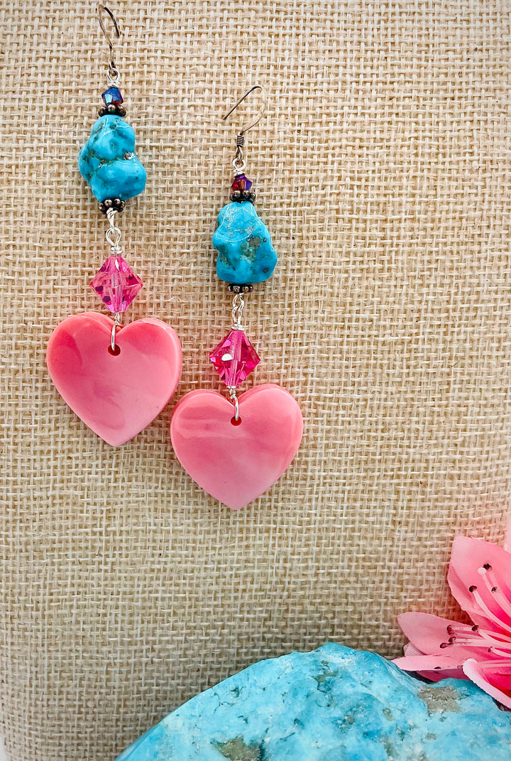 Handmade earrings featuring pink conch hearts, Swarovski crystals, and vintage Kingman turquoise. Available only from Rockstar Cowgirl online or in store in Cody, Wyoming.