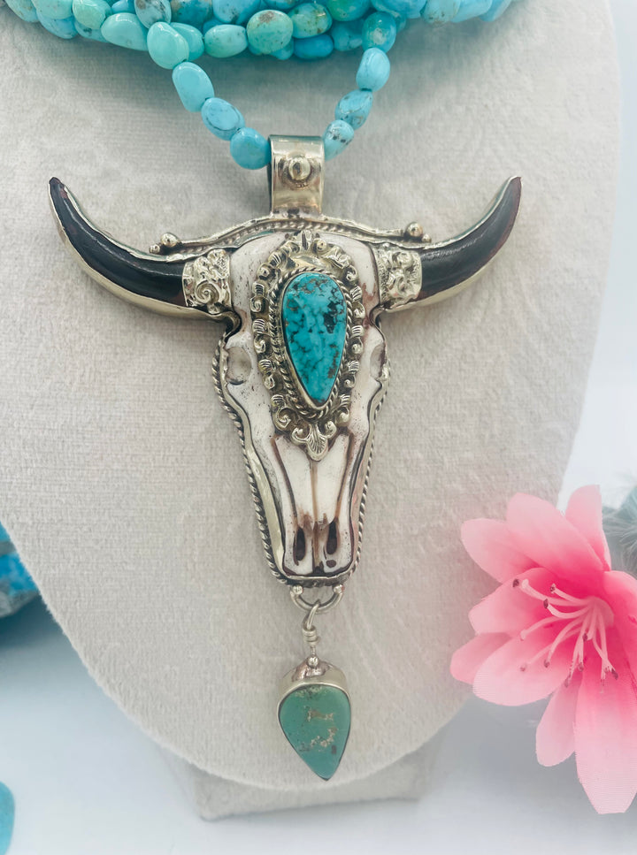 7 stranded beaded necklace featuring Sonoran turquoise nuggets, and a hand carved steer pendent with turquoise details. Available only from Rockstar Cowgirl online or in store in Cody, Wyoming.