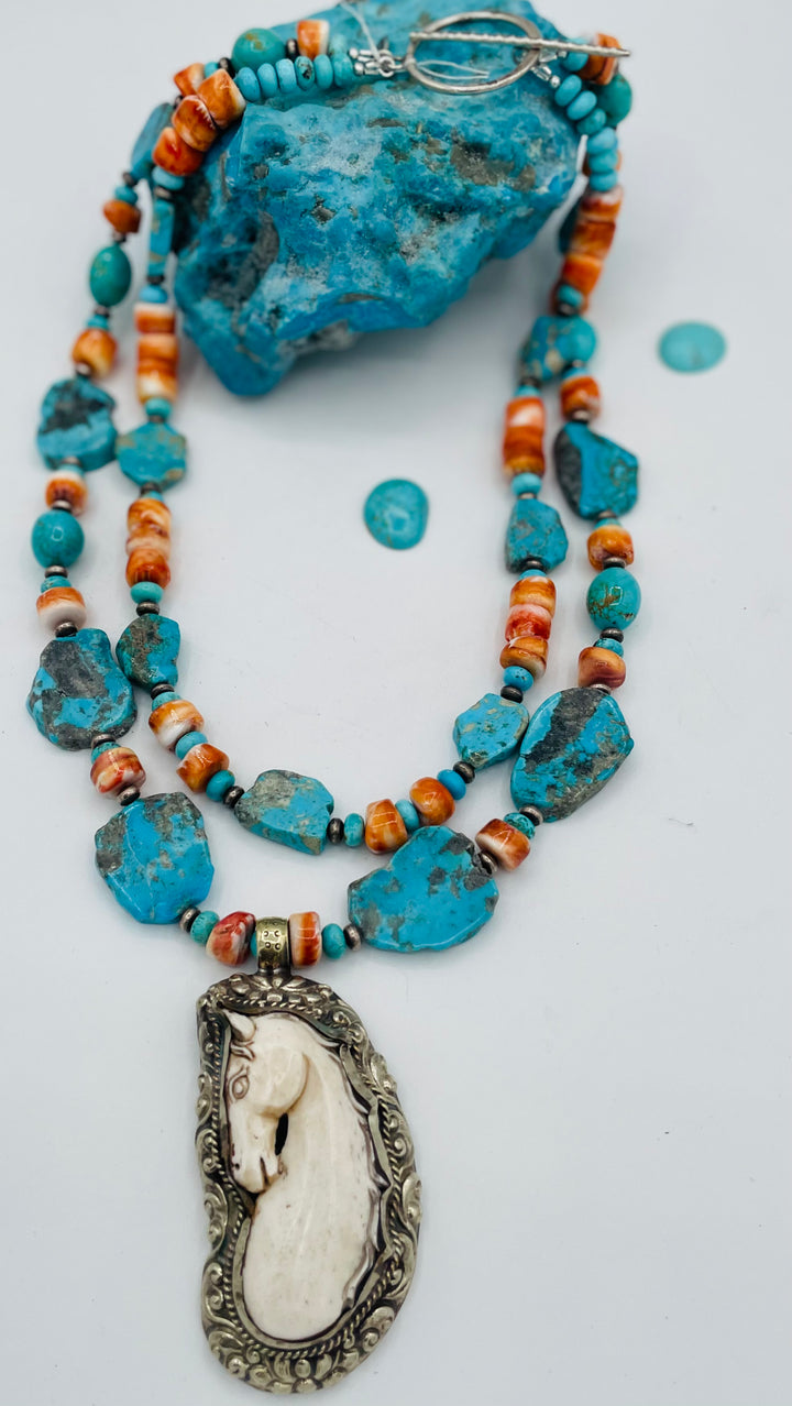 Beaded 2 strand necklace featuring Kingman turquoise, spiney oyster, sterling silver beads, with a bone and Bali silver horse pendent. Available only from Rockstar Cowgirl online or in store in Cody, Wyoming.