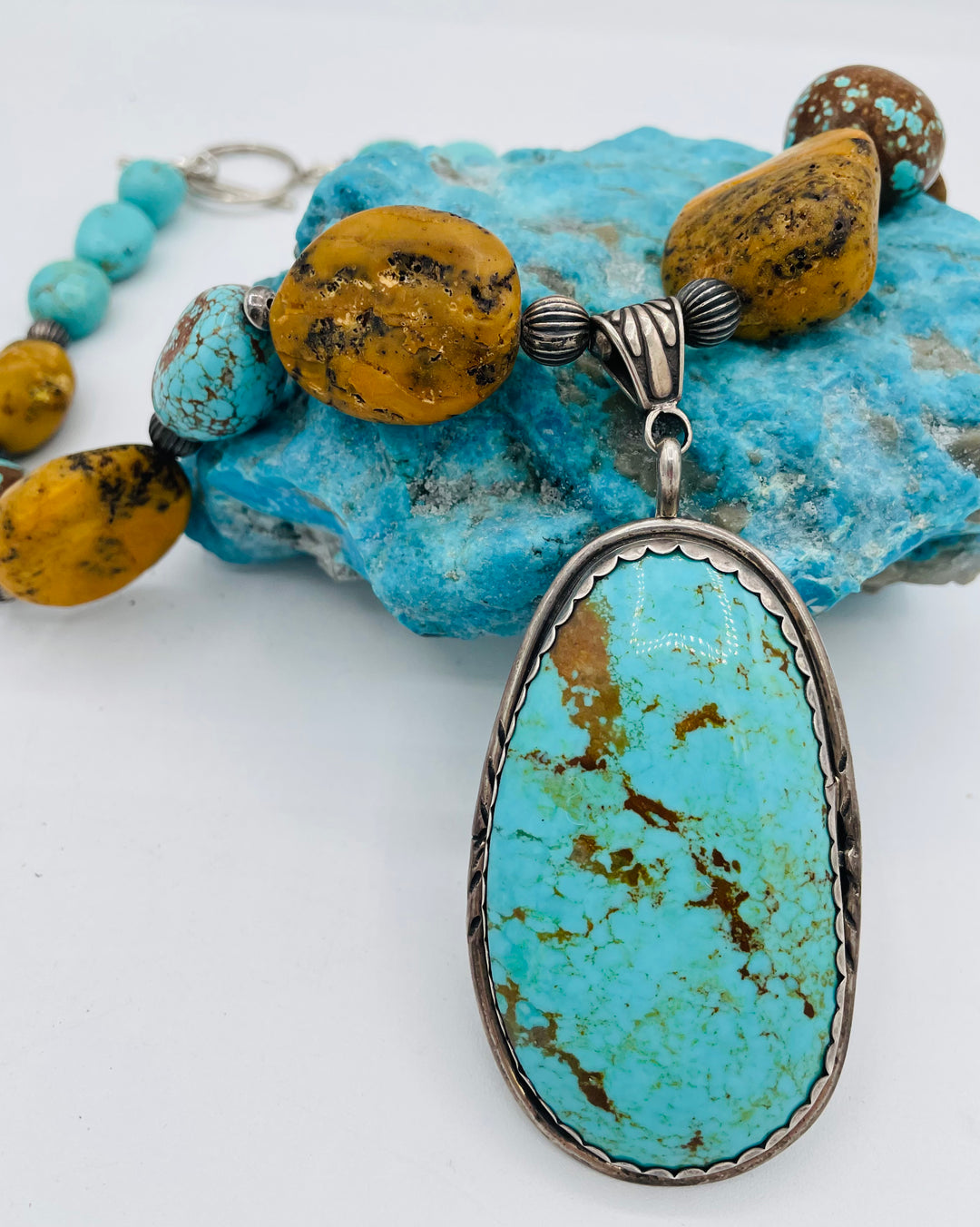 Necklace featuring Kingman turquoise, #8 turquoise, yellow and black Baltic Amber, and sterling silver beads with a Kingman turquoise and sterling silver pendent. Available only from Rockstar Cowgirl online or in store in Cody, Wyoming.