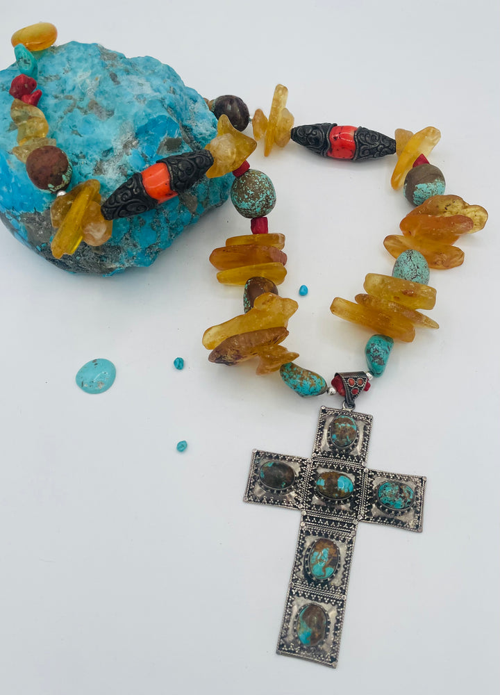 Beaded necklace featuring #8 turquoise, yellow Baltic amber, coral, sterling silver beads, silver and coral tube beads, and a sterling silver cross with #8 turquoise nuggets. Available only from Rockstar Cowgirl online or in store in Cody, Wyoming.