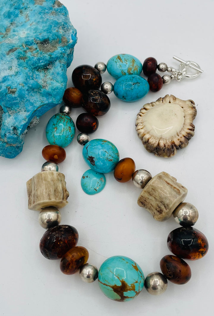 Chunky beaded necklace featuring Baltic amber, textured deer antler, sterling silver beads, and Kingman turquoise nuggets. Available only from Rockstar Cowgirl online or in store in Cody, Wyoming.