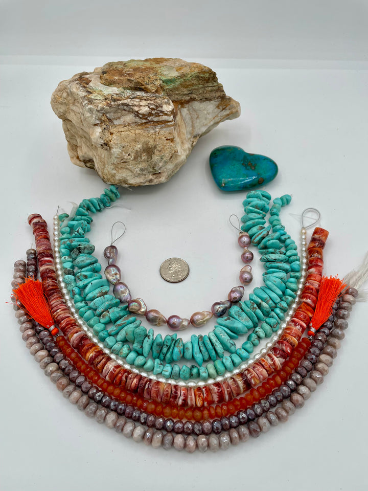 Bead box featuring natural luster baroque flame ball pearls, Campitios turquoise, small pearls, carnelian, spiney oyster, and silverite. U.S. quarter for size reference. Available only from Rockstar Cowgirl online or in store in Cody, Wyoming.