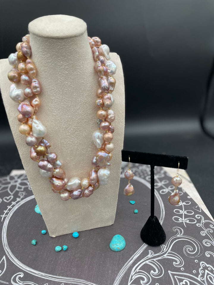 Silk knotted 3 strand baroque natural luster pearl twisted torsade or layered necklace and earring set. Featuring several shapes, sizes, and colored pearls all knotted on gold silk with a brass hook and eye clasp. Available only from Rockstar Cowgirl online or in store in Cody, Wyoming.