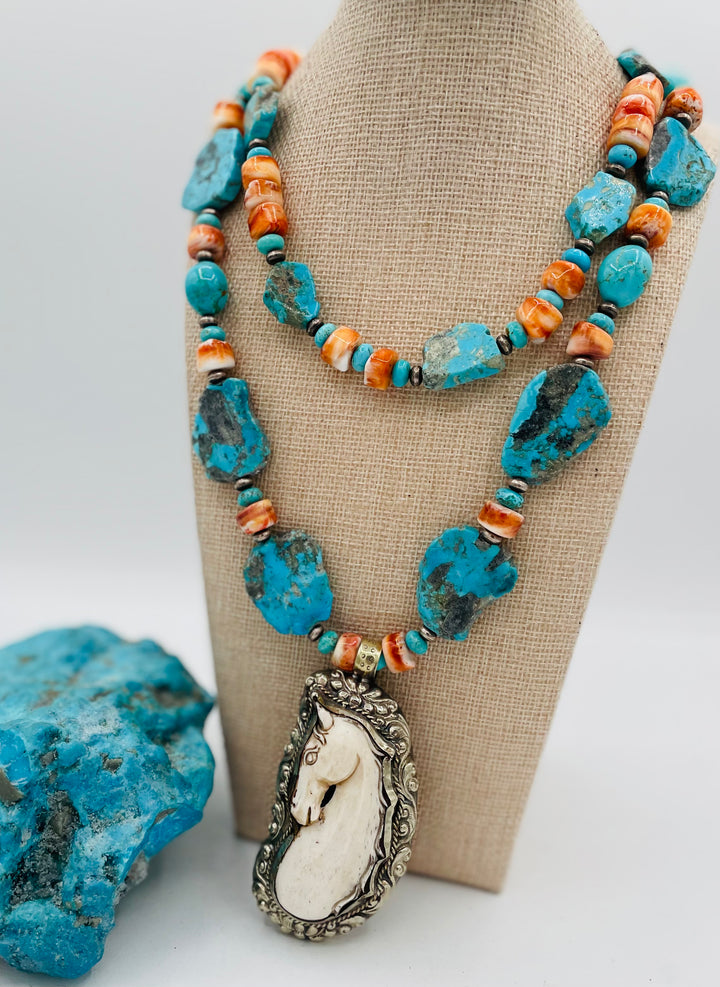 Beaded 2 strand necklace featuring Kingman turquoise, spiney oyster, sterling silver beads, with a bone and Bali silver horse pendent. Available only from Rockstar Cowgirl online or in store in Cody, Wyoming.