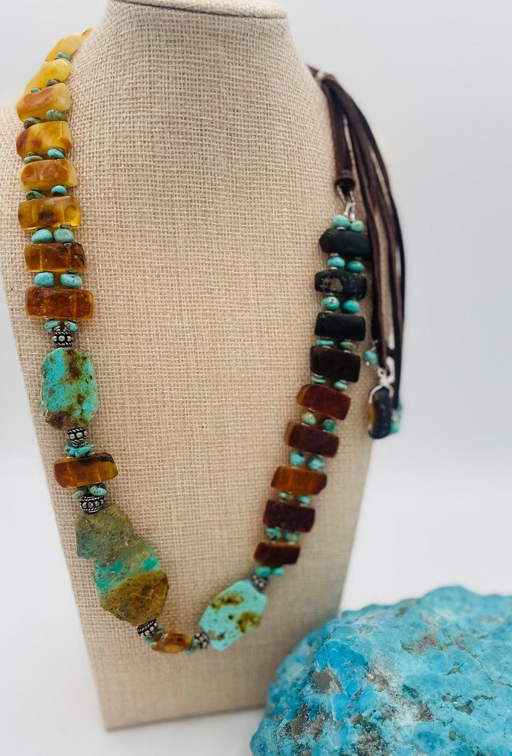Adjustable beaded hatband featuring Kingman turquoise, Sonoran turquoise, Baltic amber with silver details, and finished with deer lace in the back. Available only from Rockstar Cowgirl online or in store in Cody, Wyoming.