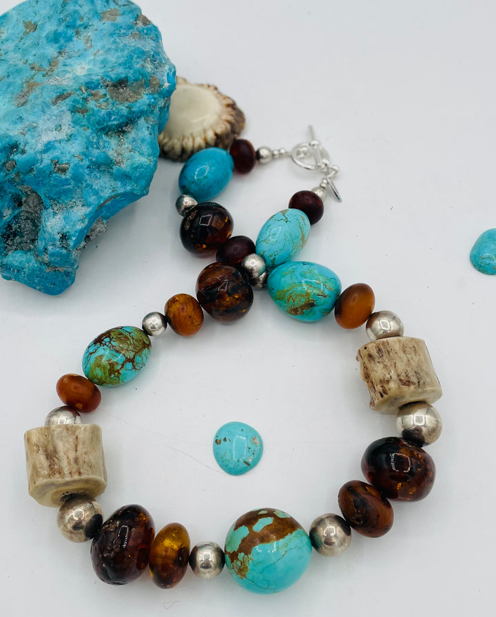 Chunky beaded necklace featuring Baltic amber, textured deer antler, sterling silver beads, and Kingman turquoise nuggets. Available only from Rockstar Cowgirl online or in store in Cody, Wyoming.