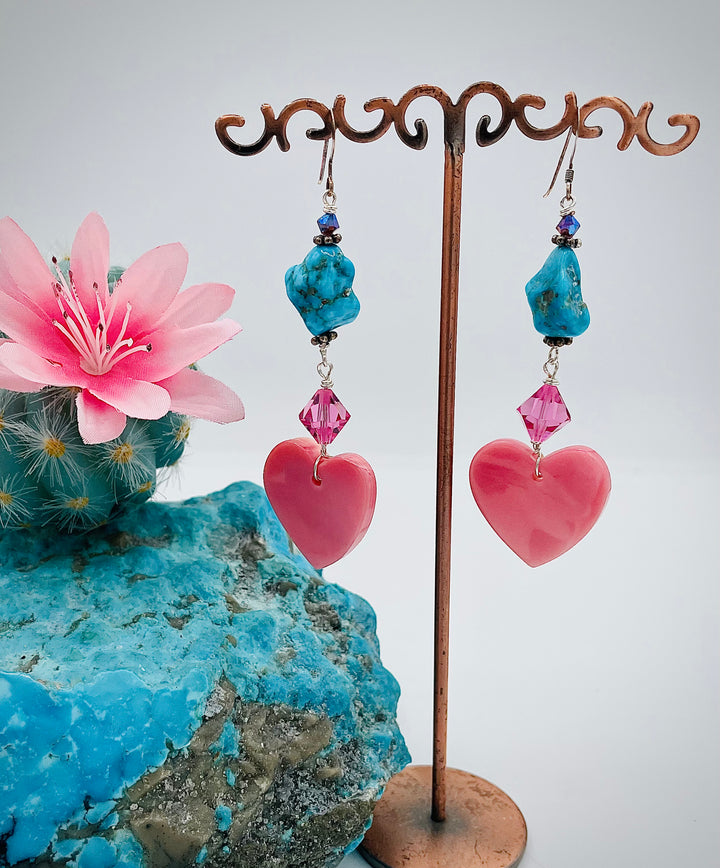 Handmade earrings featuring pink conch hearts, Swarovski crystals, and vintage Kingman turquoise. Available only from Rockstar Cowgirl online or in store in Cody, Wyoming.
