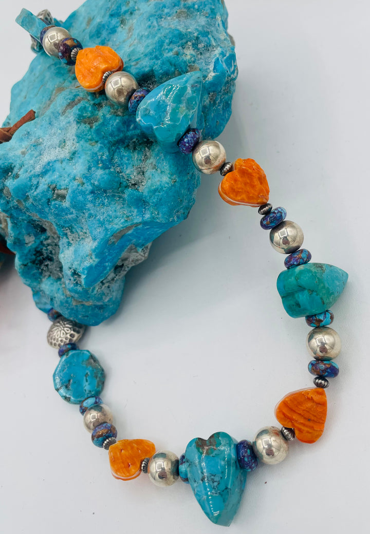 Adjustable beaded hatband featuring Kingman turquoise, purple Mojave turquoise, spiney oyster and turquoise hearts, sterling silver beads, and finished with deer lace in the back. Available only from Rockstar Cowgirl online or in store in Cody, Wyoming.