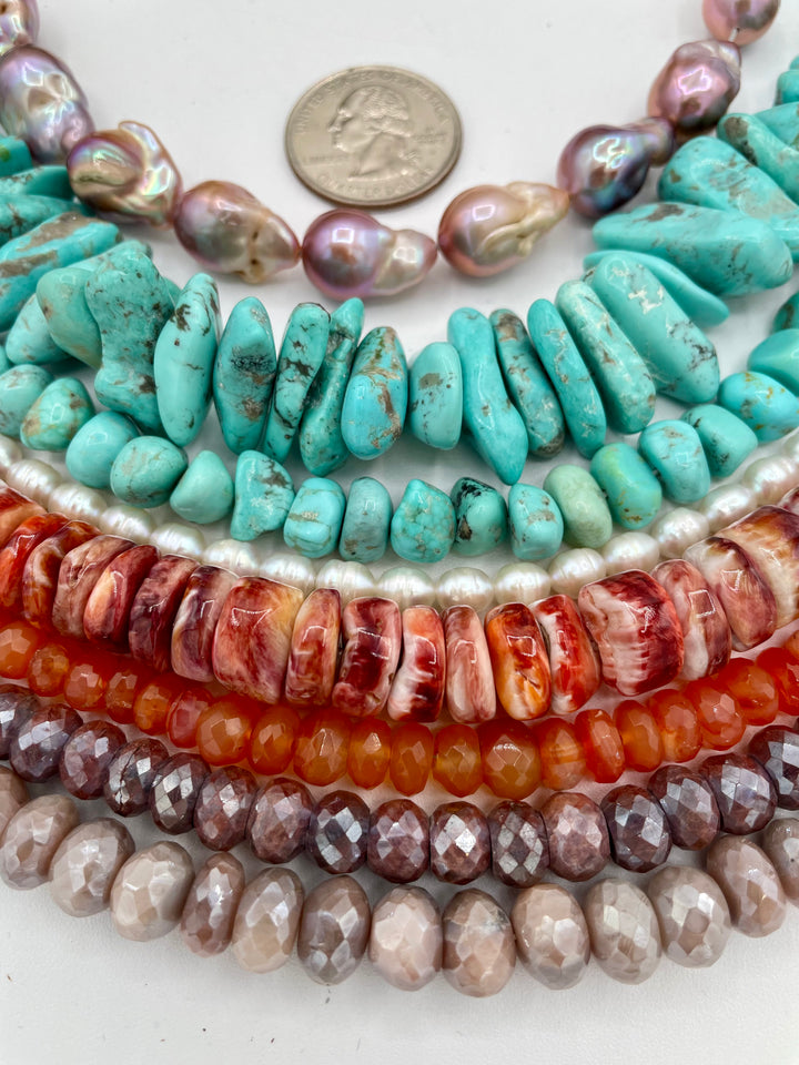 Bead box featuring natural luster baroque flame ball pearls, Campitios turquoise, small pearls, carnelian, spiney oyster, and silverite. U.S. quarter for size reference. Available only from Rockstar Cowgirl online or in store in Cody, Wyoming.