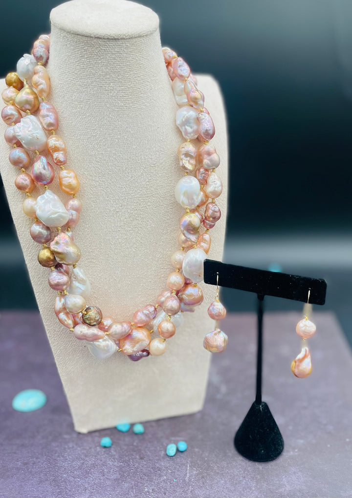 Silk knotted 3 strand baroque natural luster pearl twisted torsade or layered necklace and earring set. Featuring several shapes, sizes, and colored pearls all knotted on gold silk with a brass hook and eye clasp. Available only from Rockstar Cowgirl online or in store in Cody, Wyoming.