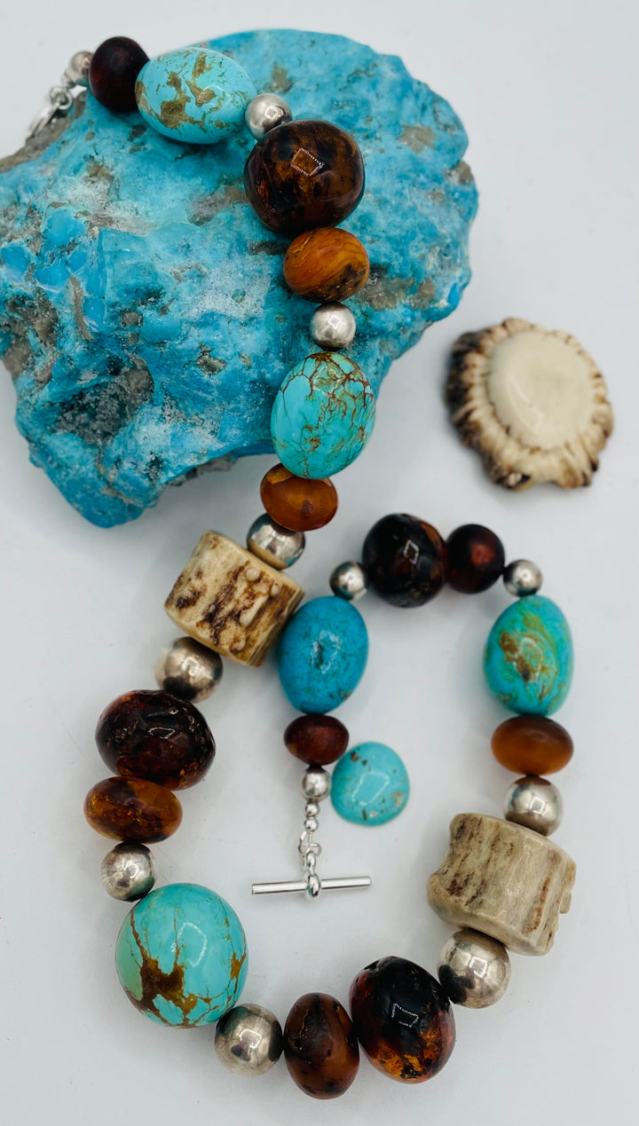 Chunky beaded necklace featuring Baltic amber, textured deer antler, sterling silver beads, and Kingman turquoise nuggets. Available only from Rockstar Cowgirl online or in store in Cody, Wyoming.