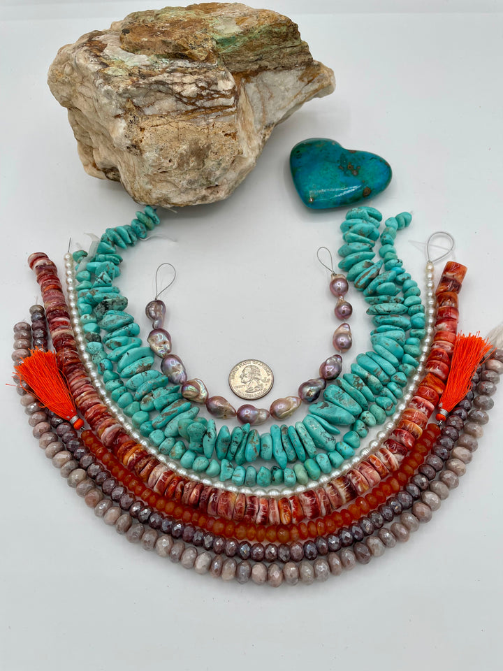 Bead box featuring natural luster baroque flame ball pearls, Campitios turquoise, small pearls, carnelian, spiney oyster, and silverite. U.S. quarter for size reference. Available only from Rockstar Cowgirl online or in store in Cody, Wyoming.