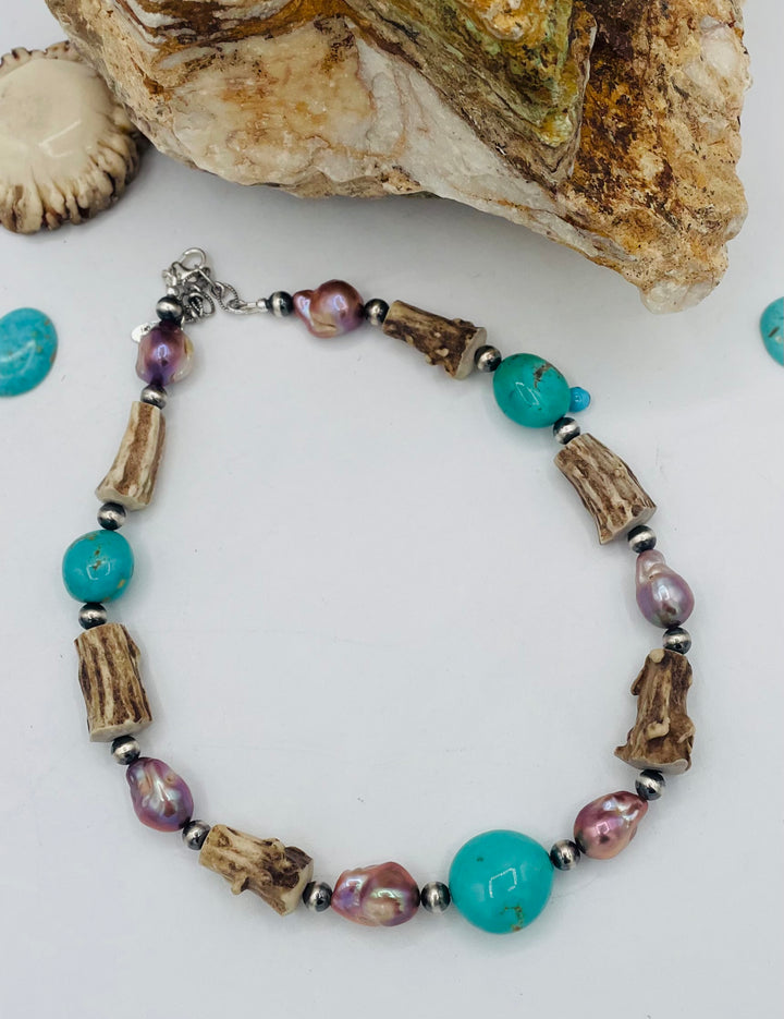 Beaded necklace featuring Kingman turquoise nuggets, baroque natural luster pearls, textured deer antler, and sterling silver beads. Available only from Rockstar Cowgirl online or in store in Cody, Wyoming.