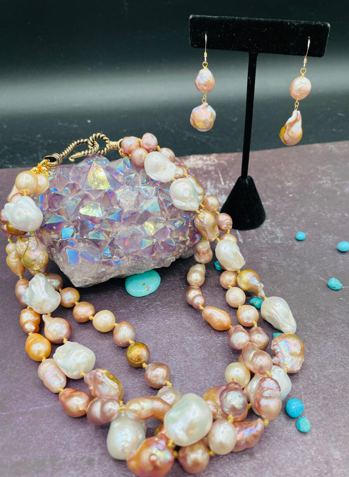 Silk knotted 3 strand baroque natural luster pearl twisted torsade or layered necklace and earring set. Featuring several shapes, sizes, and colored pearls all knotted on gold silk with a brass hook and eye clasp. Available only from Rockstar Cowgirl online or in store in Cody, Wyoming.