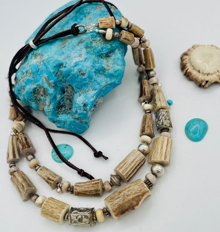 Adjustable beaded hat band that doubles as a two strand necklace featuring deer antler, Campitios turquoise, Repousse beads, sterling silver beads, and finished with deer lace and a silicone slide bead. Available only from Rockstar Cowgirl online or in store in Cody, Wyoming.