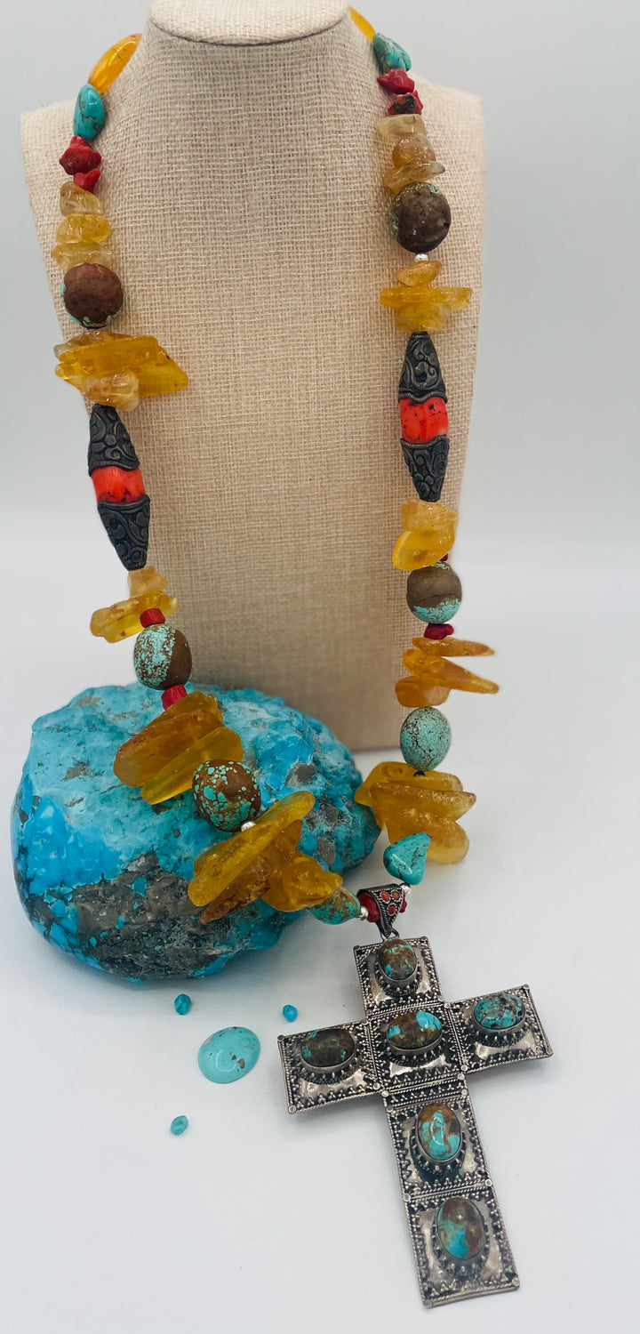 Beaded necklace featuring #8 turquoise, yellow Baltic amber, coral, sterling silver beads, silver and coral tube beads, and a sterling silver cross with #8 turquoise nuggets. Available only from Rockstar Cowgirl online or in store in Cody, Wyoming.