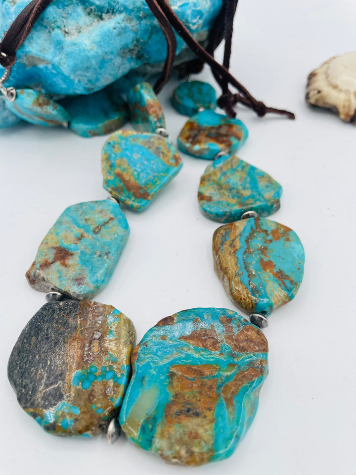 Adjustable beaded hatband that double as a necklace featuring Kingman turquoise flats and sterling silver beads finished with deer lace in the back. Available only from Rockstar Cowgirl online or in store in Cody, Wyoming.