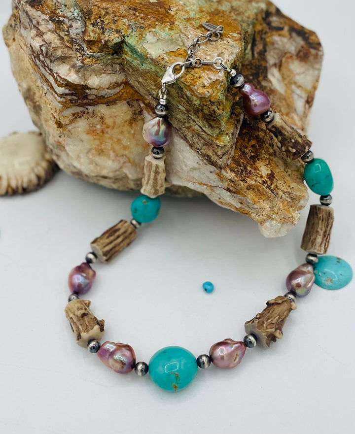Beaded necklace featuring Kingman turquoise nuggets, baroque natural luster pearls, textured deer antler, and sterling silver beads. Available only from Rockstar Cowgirl online or in store in Cody, Wyoming.