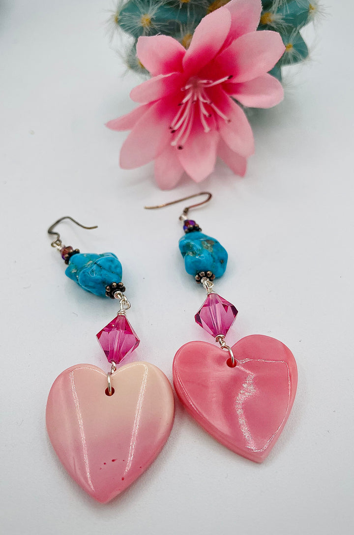 Handmade earrings featuring pink conch hearts, Swarovski crystals, and vintage Kingman turquoise. Available only from Rockstar Cowgirl online or in store in Cody, Wyoming.