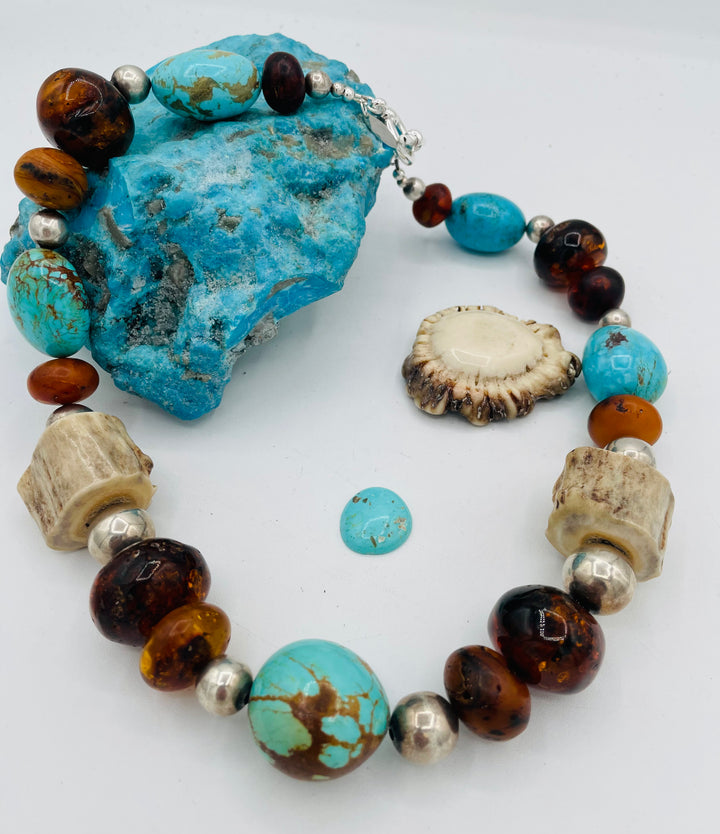 Chunky beaded necklace featuring Baltic amber, textured deer antler, sterling silver beads, and Kingman turquoise nuggets. Available only from Rockstar Cowgirl online or in store in Cody, Wyoming.