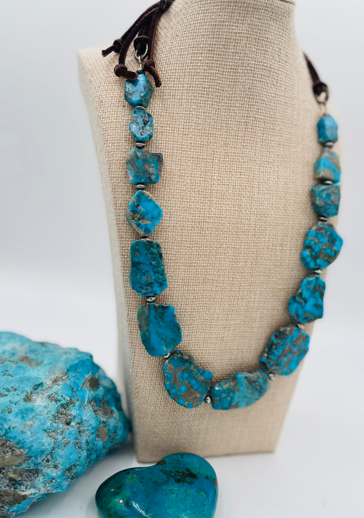 Adjustable beaded hatband that doubles as a necklace featuring Ithaca Peak turquoise and sterling silver beads and finished with deer lace in the back. Available only from Rockstar Cowgirl online or in store in Cody,, Wyoming.