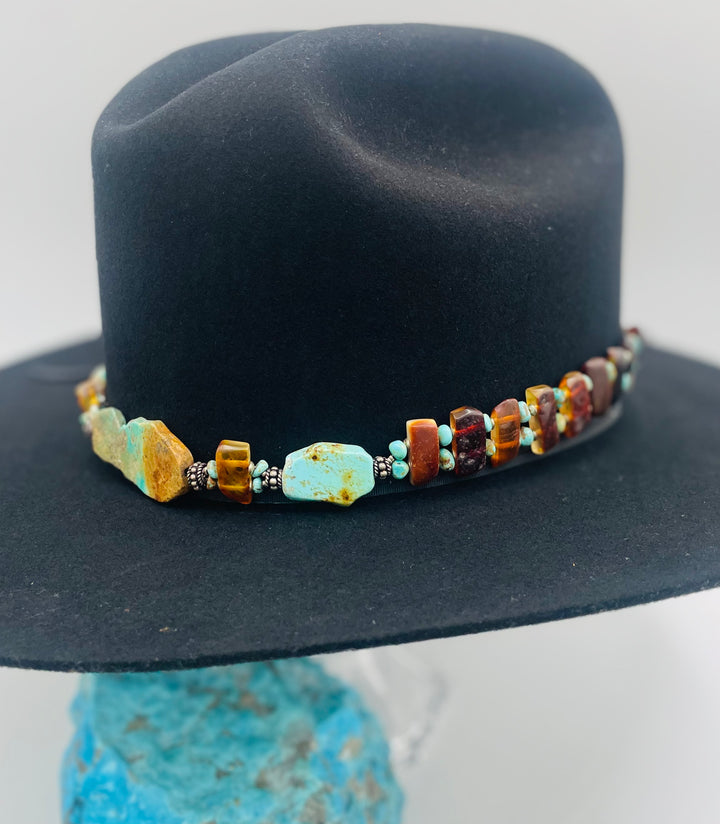 Adjustable beaded hatband featuring Kingman turquoise, Sonoran turquoise, Baltic amber with silver details, and finished with deer lace in the back. Available only from Rockstar Cowgirl online or in store in Cody, Wyoming.