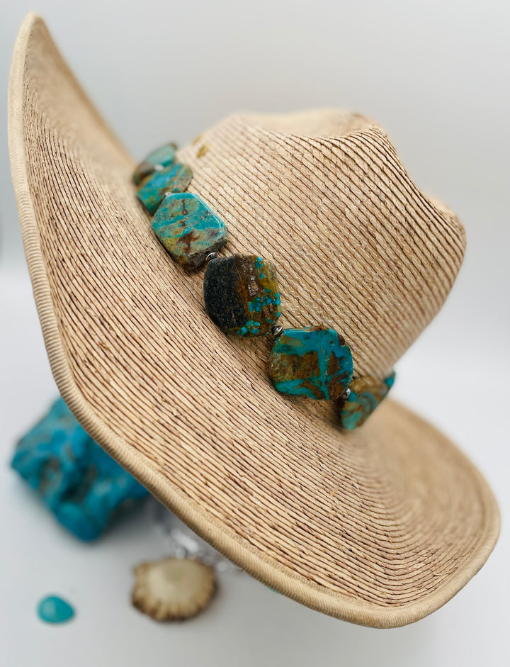 Adjustable beaded hatband that double as a necklace featuring Kingman turquoise flats and sterling silver beads finished with deer lace in the back. Available only from Rockstar Cowgirl online or in store in Cody, Wyoming.