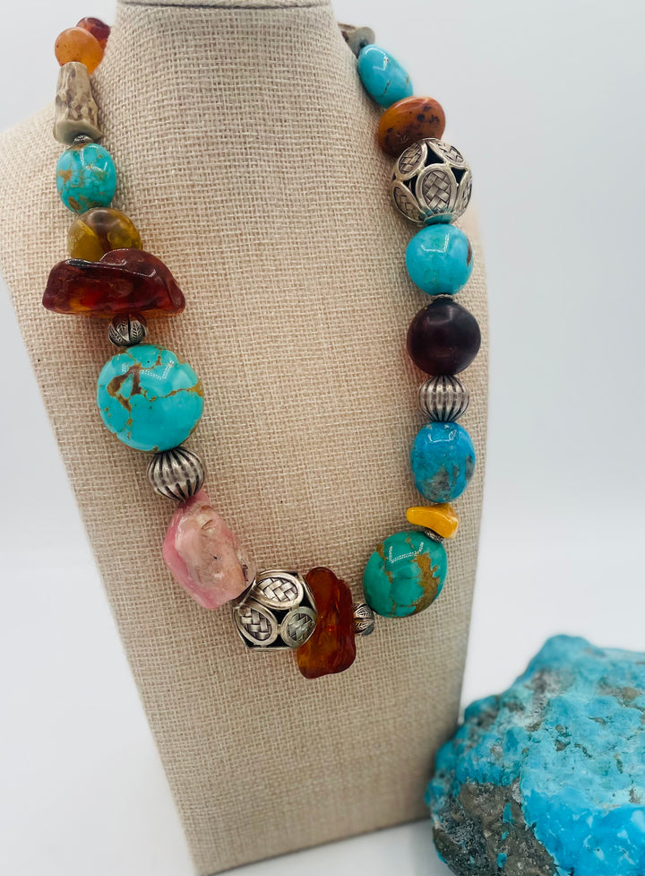 Chunky beaded necklace featuring Kingman turquoise, Ithaca Peak turquoise, textured deer antler, Baltic amber, pink opal, and sterling silver beads. Available only from Rockstar Cowgirl online or in store in Cody, Wyoming.