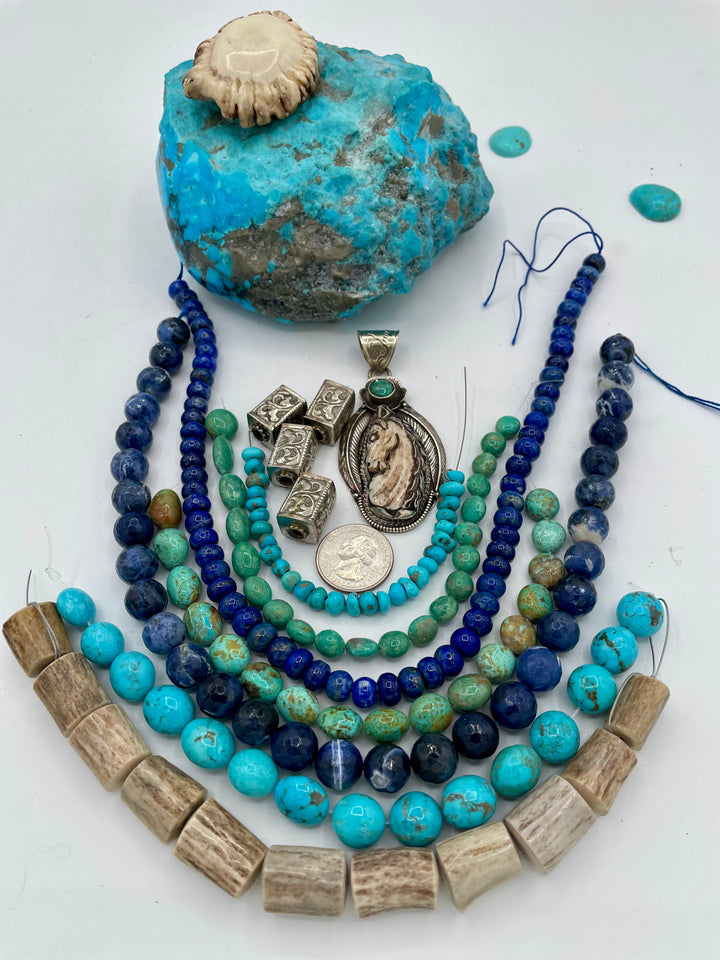 Bead box featuring strands of Kingman turquoise in blue and green, sodalite, denim lapis, Campitios turquoise, repousse beads, and hand carved bone horse pendent in Bali silver. U.S. quarter for size reference. One of a kind box available only from 
Rockstar Cowgirl online or in store in Cody, Wyoming.